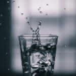 water pouring on clear drinking glass