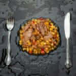 stainless steel fork and bread knife on black ceramic plate